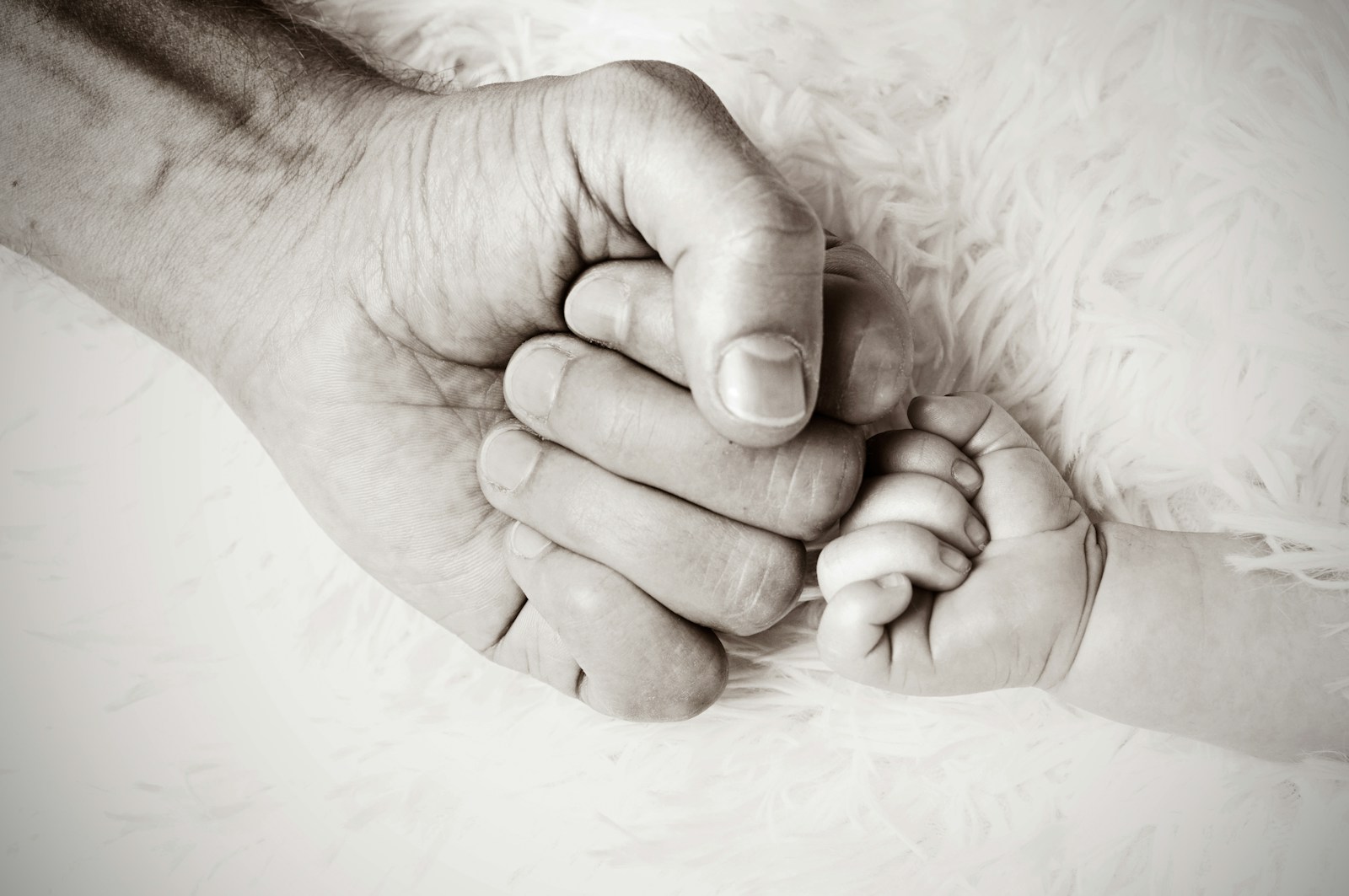 Photo by Heike Mintel a close up of a person holding a baby's hand