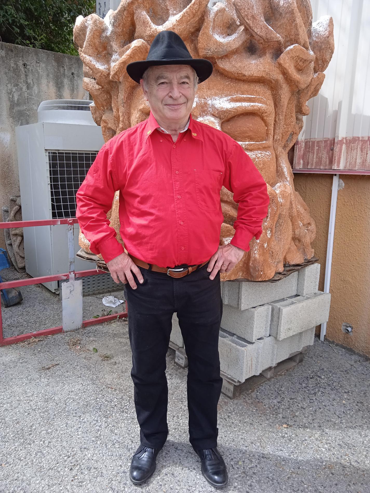 a group of people standing on top of a beach under a cloudy blue sky