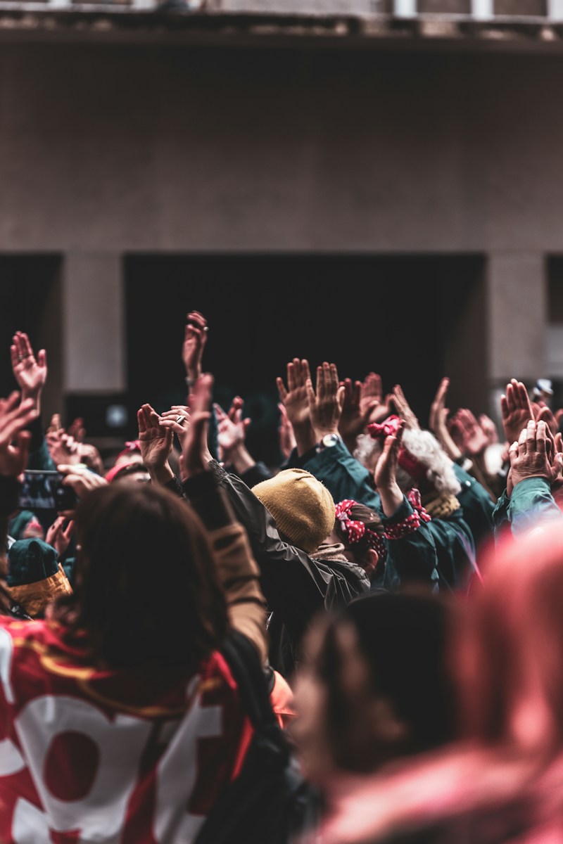 Accueil 1 a large group of people with their hands in the air